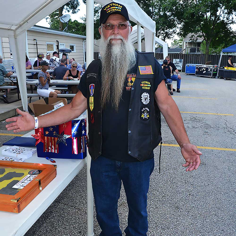 Vet with long beard and leather vest at the event.